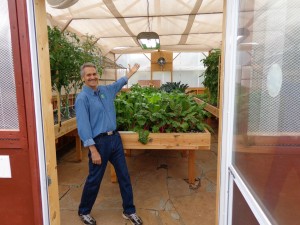 Colle Davis, Lead Inventor, showing the interior of a 16' x 33' Portable Farms® Aquaponics System.